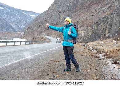 Travel Woman Hitchhiking. Beautiful Young Female Hitchhiker By The Road During Vacation Trip In Mountains