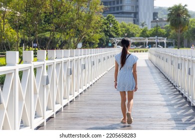 Travel Woman Walk On The White Wooden Bridge