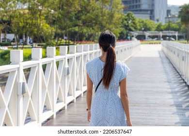 Travel Woman Walk On The White Wooden Bridge