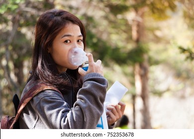 Travel Women Using Oxygen Can For Prevent Altitude Mountain Sickness (AMS) Symptom