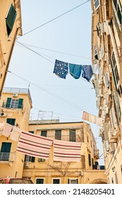 Travel The World And Youll See Things Are Done Differently. Low Angle Shot Of Clothing Hanging From Clothing Lines Between Buildings In A Foreign City.