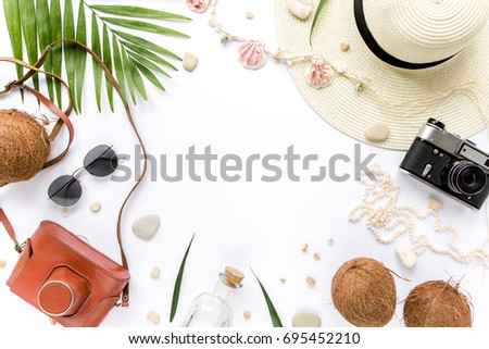 Traveler accessories, tropical palm leaf branches on white background with empty space for text. Travel vacation concept. Summer background. Road frame set. Flat lay, top view.