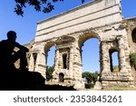 Traveler admiring the Porta Maggiore, in Rome