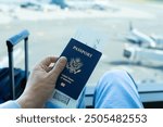 Traveler at the airport with USA passport in hand