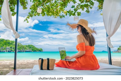 Traveler Asian woman relaxing at sea beach using laptop, Businesswoman on vacation at private resort, Attraction place tourist travel Phuket Thailand summer holiday, Tourism beautiful destination Asia