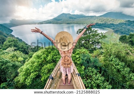 Traveler with backpack and arms up enjoying freedom 