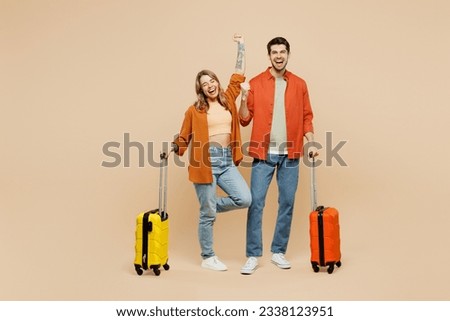 Traveler couple two friend family man woman wear casual clothes holding passport ticket bag isolated on plain beige background. Tourist travel abroad in free time rest getaway. Air flight trip concept