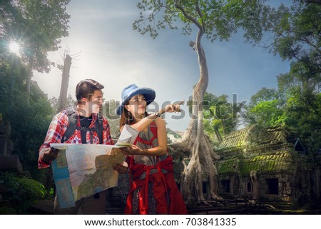 Traveler finding next camping point by a map, Ta prohm temple or Tom rider   is on Angkor wat temple area in Siem reap, Combodia, Asia, unesco, amazing, travel and temple concept
