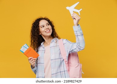 Traveler Fun Happy Black Teen Girl Student Wear Casual Clothes Hold Passport Tickets Airplane Isolated On Plain Yellow Background. Tourist Travel High School Study Abroad Getaway. Air Flight Concept