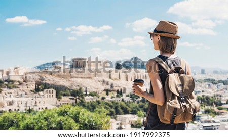Traveler girl enjoying vacations in Athens, Greece. Young woman looking at Acropolis