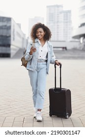 Traveler Girl Using Smartphone In A City. Smiling Woman Tourist Looking At Mobile Phone Outdoors