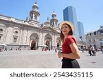 Traveler girl visiting Santiago de Chile with the Metropolitan Cathedral on the background, Santiago de Chile, South America