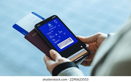 Traveler holding mobile phone with electronic boarding pass on the screen. Passenger using digital boarding pass for air travel. - Powered by Shutterstock - Get 15% off with code: PIKWIZARD15