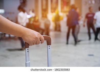 Traveler Holding Suitcases At Airport Departure Lounge Travel In Airplane Terminal Background,traveling Baggage In Waiting Checkin Area, Focus On Hands. Summer Holiday Vacation Concept