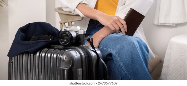 Traveler with Luggage and Camera Ready for Summer Vacation Flight Trip. Travel Essentials and Preparation Concept - Powered by Shutterstock