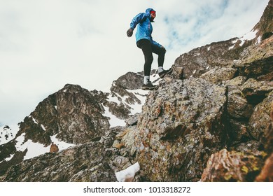 Traveler Man climbing in rocky mountains Lifestyle travel concept adventure outdoor active vacations sport survival wilderness - Shutterstock ID 1013318272