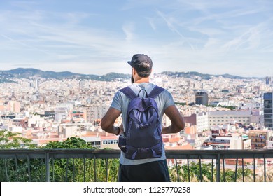 Traveler Man Looking On A Big City, Travel And Active Lifestyle Concept.Bearded Tourist Man With Backpack Enjoy Beautiful Panoramic View Of Modern European City