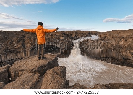 Similar – Image, Stock Photo Man in Orange Jacket Enjoying Misty Iceland Landscape