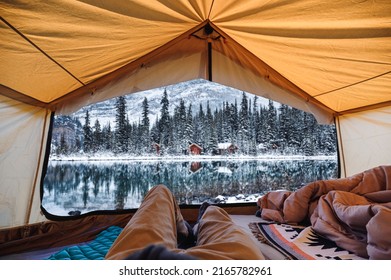 Traveler Man Relaxing In Large Tent With Cottage In The Forest At Lake O'hara On Winter