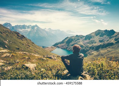 Traveler Man relaxing meditation with serene view mountains and lake landscape Travel Lifestyle hiking concept summer vacations outdoor 