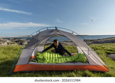 Traveler Man Setting Up Tent On Beach