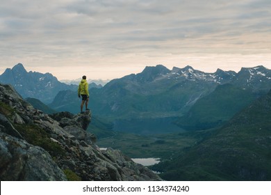 Traveler man standing on the edge cliff over clouds sunset mountains travel adventure lifestyle journey vacations in Norway - Shutterstock ID 1134374240