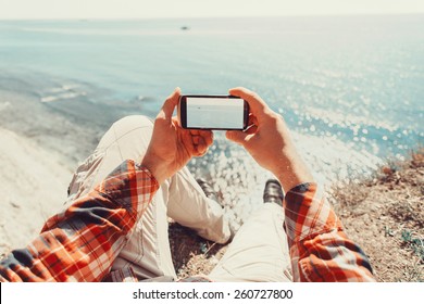 Traveler Man Taking Photographs Sea With Smartphone. Point Of View Shot