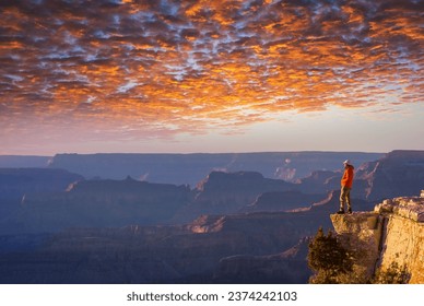 Traveler on cliff mountains over Grand Canyon National Park, Arizona, USA.Inspiring emotion. Travel Lifestyle journey success motivation concept adventure  vacations outdoor concept. - Powered by Shutterstock