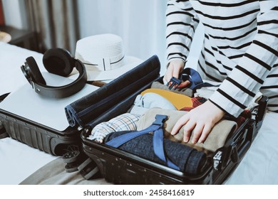 Traveler Packing Suitcase for Upcoming Journey - Powered by Shutterstock