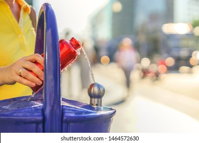  Traveler Refills A Bottle Of Drinking Water . Concept - A Hot Summer Day In The City, Heat Wave In The City