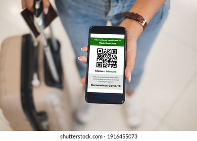 Traveler shows health passport of vaccination certification on phone at airport, to certicy that have been vaccinated of coronavirus covid-19