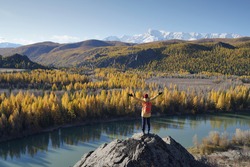 Traveler Standing And Hands Raising On The Rock And Looking At The Chuya River Valley In Altai Mountains