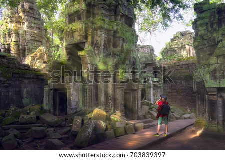 Traveler take a photo, Ta prohm temple or Tom rider temple  is on Angkor wat temple area in Siem reap, Combodia, Asia, unesco, amazing, travel and temple concept