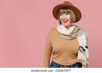 Traveler Tourist Surprised Fun Mature Elderly Lady Woman 55 Years Old Wears Brown Shirt Hat Scarf Look Aside Isolated On Plain Pastel Light Pink Background Studio Portrait. Air Flight Journey Concept