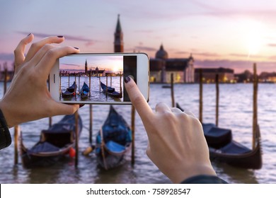 Traveler tourist taking beautiful landscape photo of european sunset during holiday vacation 