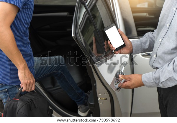 traveler or tourists go in to the car driver use\
smart phone from taxi  car sharing with white mobile phone screen\
with  clipping path