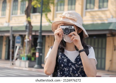 Traveler, travel asian young woman or girl use camera take photo, old town street, city tourism on happy sunny day. Backpacker tourist, holiday trip, summer or vacation, hobby concept.