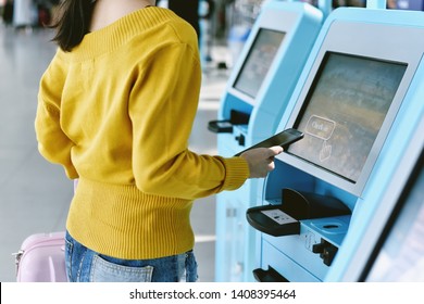 Traveler using a self check-in machine kiosk service at airport, Technology and smart application to confirm flight booking details, Travel concept.