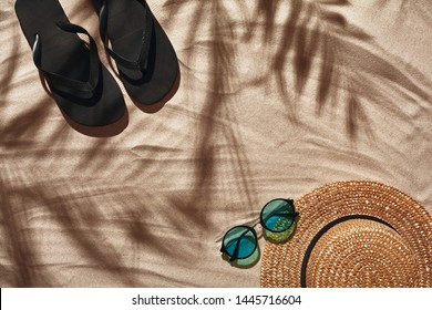 Traveler Vacation Accessories Are Laid Out On A White Beach Sand. Flat Lay, Top View.