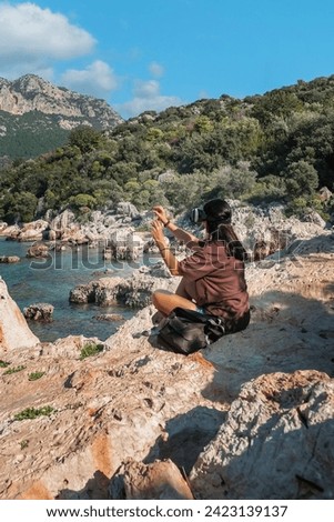 Traveler in virtual reality headset augmented with virtual reality in the concept of a beautiful mountain landscape, mountain trip, VR,reality, virtual,