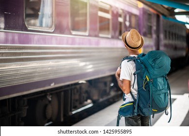 Traveler Waits Train At Train Station For Travel In Summer. Travel Concept.