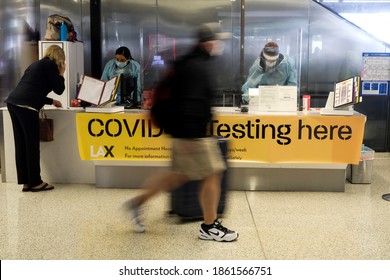 A traveler walks by a COVID-19 testing site at the Los Angeles International Airport (LAX) in Los Angeles, Wednesday, Nov. 25, 2020.