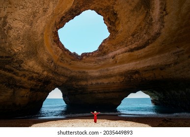 Traveler woman enjoying alone the beaches of the Algarve, Portugal