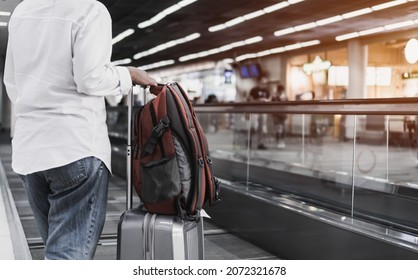 Traveler woman hold luggage on escalator at terminal airport or transit flight with suitcase in journey vacation holiday at elevator arrival international airport, Lifestyle by airplane in Asia
