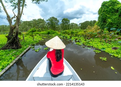 Traveler Woman On A Boat Tour Along The Canals In The Mangrove Forest. This Is An Eco Tourism Area At Mekong Delta In An Giang, Vietnam