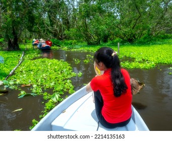 Traveler Woman On A Boat Tour Along The Canals In The Mangrove Forest. This Is An Eco Tourism Area At Mekong Delta In An Giang, Vietnam