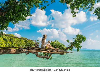 Traveler woman on tree branch using tablet joy nature scenic landscape Railay beach Krabi, Digital nomad work travel Phuket Thailand summer holiday vacation trip, Tourism beautiful destination Asia