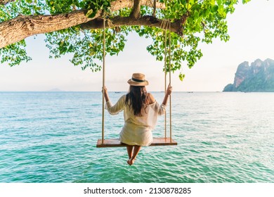 Traveler woman relaxing on swing above Andaman sea Railay beach Krabi, Leisure tourist travel Phuket Thailand summer holiday vacation trip, Beautiful destinations place Asia, Happy dream concept - Shutterstock ID 2130878285