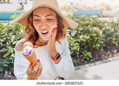 Traveler Woman Took A Bite Of Cold And Sweet Ice Cream And Felt A Sharp Pain In Her Teeth Due To Their Hypersensitivity. Medical Insurance On Vacation Concept.