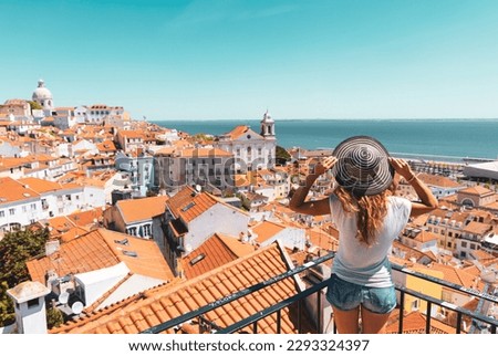 Traveler Woman, tourist on balcony looking at panoramic view of Lisboa- Tourism, vacation, travel in Portugal